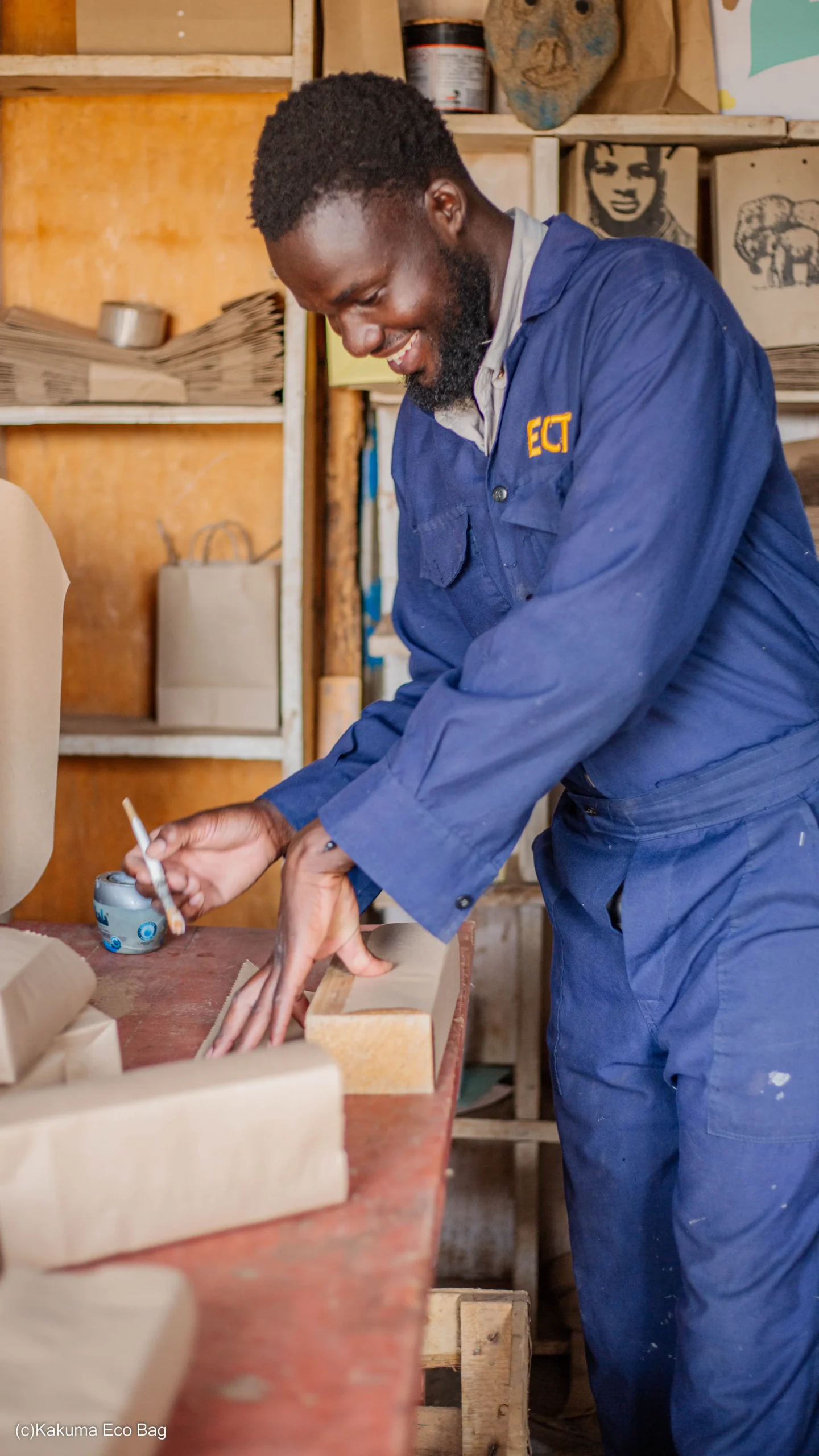 smiling young man in blue overalls