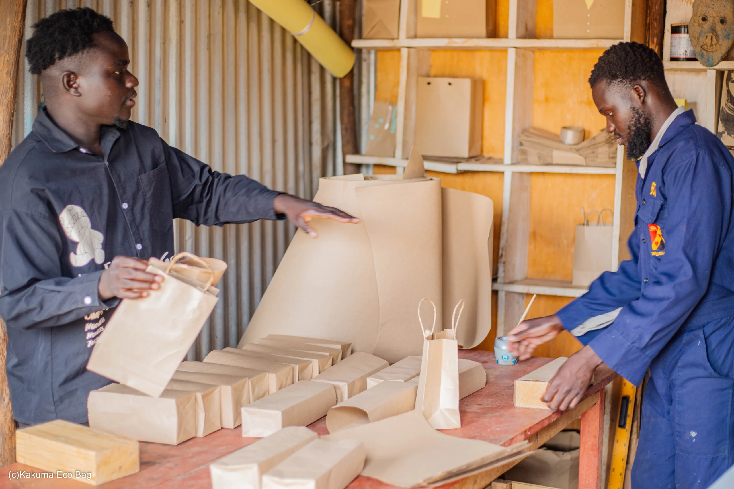 two young men making khaki packaging bags