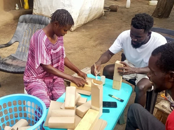 three young people making khaki packaging bags